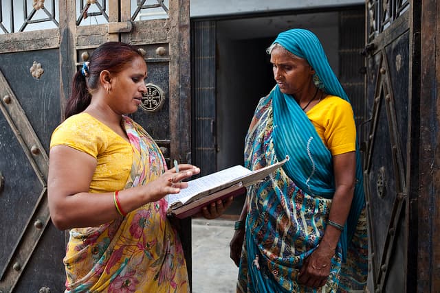 Field researcher conducting a community survey